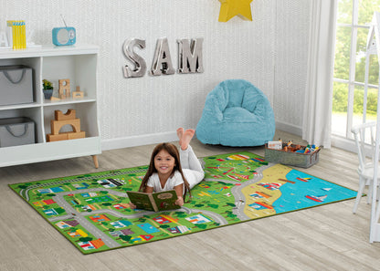 Child reading a book on a colorful rug in a room with a 'SAM' sign on the wall.