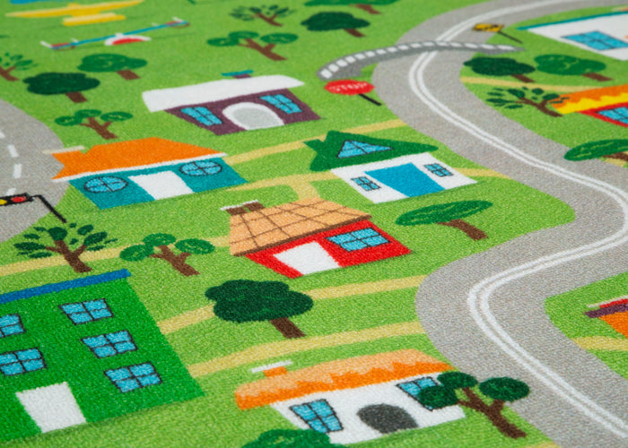 Children's play rug with a town layout featuring houses, roads, and trees.