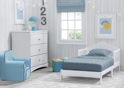 Children's bedroom with white crib, blue chair, and dresser in a bright room.