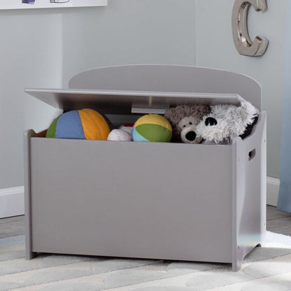 A gray toy box with a lid open showing various toys inside, placed in a room with a wall-mounted letter 'C' decor.