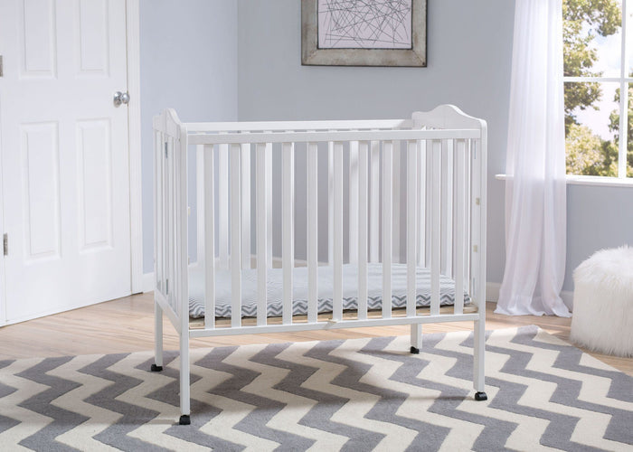 Delta Children Bianca (130) Portable Folding Crib with Mattress, room shot a1a